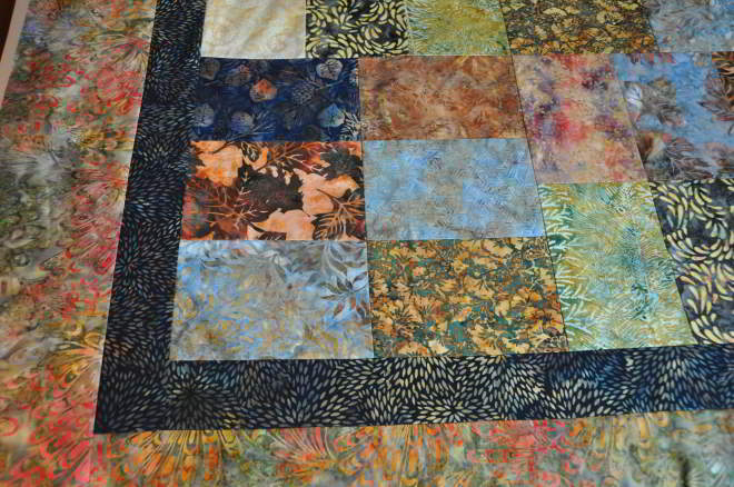 Close up a corner showing some of the fabrics. As well as a better look at the innor and outer borders.