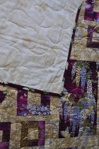 A shot of the Crane Paradise quilt's backing fabric against the wisteria block.